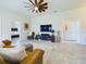 Comfortable living room with a large TV and view to the bedroom at 1134 Legatto Loop, Dundee, FL 33838