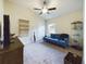 Cozy sitting room with vaulted ceiling, couch, TV, and plenty of space at 1134 Legatto Loop, Dundee, FL 33838