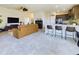 Open-concept living room with modern kitchen, tile floors, and stylish decor at 1134 Legatto Loop, Dundee, FL 33838