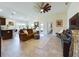 Spacious living room with tile flooring, comfortable seating, and a unique ceiling fan at 1134 Legatto Loop, Dundee, FL 33838