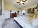 Bright main bedroom featuring carpet floors and a view to the living room at 1134 Legatto Loop, Dundee, FL 33838