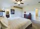 Inviting main bedroom with neutral tones, ceiling fan, and en-suite bathroom at 1134 Legatto Loop, Dundee, FL 33838