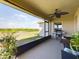 This screened-in patio features a grill, ceiling fan and view of the surrounding landscape at 1134 Legatto Loop, Dundee, FL 33838