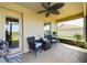 This screened-in patio features furniture, ceiling fan and view of the backyard at 1134 Legatto Loop, Dundee, FL 33838