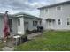 Well-maintained backyard with a concrete patio, grill, and cozy outdoor seating, perfect for entertaining guests at 117 Tremont Dr, Winter Haven, FL 33884