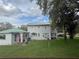Well-kept backyard featuring mature trees providing a shady and private outdoor retreat at 117 Tremont Dr, Winter Haven, FL 33884