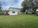 Extensive backyard showcasing green space with trees and sheds, offering plenty of room for outdoor enjoyment at 117 Tremont Dr, Winter Haven, FL 33884
