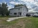 Charming two-story home featuring a driveway leading to a detached garage and a well-maintained lawn at 117 Tremont Dr, Winter Haven, FL 33884