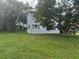 View of a two-story home with tidy landscaping, surrounded by lush greenery, offering a peaceful retreat at 117 Tremont Dr, Winter Haven, FL 33884