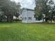 A well-kept two-story home with neat lawn, complemented by mature trees offering shade and natural beauty at 117 Tremont Dr, Winter Haven, FL 33884