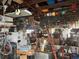 Cluttered garage filled with various tools, equipment, and storage boxes at 117 Tremont Dr, Winter Haven, FL 33884