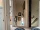 Hallway with wooden banister and multiple framed photographs at 117 Tremont Dr, Winter Haven, FL 33884