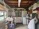 Utility room with a washer, dryer, and exposed wooden ceiling beams at 117 Tremont Dr, Winter Haven, FL 33884