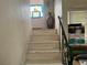 Stairway with wooden steps, and a stained glass window at the top at 117 Tremont Dr, Winter Haven, FL 33884