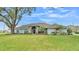 Charming single-story home featuring a manicured lawn and a beautiful stone-accented entryway at 1201 Grey Fox Hollow Dr, Winter Haven, FL 33880