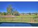 The property features a large grassy backyard with a chain link fence at 136 Krenson Bay Loop, Winter Haven, FL 33881