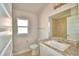 Well-lit bathroom showcasing the tile shower reflected in the mirror at 136 Krenson Bay Loop, Winter Haven, FL 33881