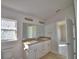 Bright bathroom features double sink vanity, decorative window, and modern fixtures at 136 Krenson Bay Loop, Winter Haven, FL 33881