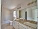Bright bathroom featuring double vanity, spacious mirror, and ample cabinet space at 136 Krenson Bay Loop, Winter Haven, FL 33881