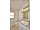 Well-lit bathroom with tile shower reflected in the vanity mirror at 136 Krenson Bay Loop, Winter Haven, FL 33881
