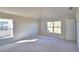 Bright bedroom with large windows offering plenty of natural light, with neutral carpet at 136 Krenson Bay Loop, Winter Haven, FL 33881