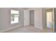 Cozy bedroom with natural light, closet, and neutral carpet at 136 Krenson Bay Loop, Winter Haven, FL 33881