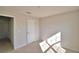 Sunlit bedroom boasts neutral tones, plush carpet, and entry to other room at 136 Krenson Bay Loop, Winter Haven, FL 33881