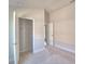 Bright bedroom with open closet, neutral carpet, and view to the hallway at 136 Krenson Bay Loop, Winter Haven, FL 33881