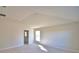 Inviting bedroom bathed in light, showcasing neutral walls, plush carpet, and doorway to bathroom at 136 Krenson Bay Loop, Winter Haven, FL 33881