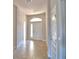 Bright entryway with tile flooring, a transom window, and white doors for a welcoming entrance at 136 Krenson Bay Loop, Winter Haven, FL 33881