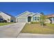 Charming single-story home with a two-car garage, manicured lawn, and inviting curb appeal at 136 Krenson Bay Loop, Winter Haven, FL 33881