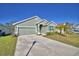 Charming single-story home with a two-car garage, manicured lawn, and inviting curb appeal at 136 Krenson Bay Loop, Winter Haven, FL 33881