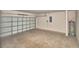 Spacious garage with roll-up door and concrete flooring, ideal for storage or parking at 136 Krenson Bay Loop, Winter Haven, FL 33881