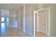 Neutral hallway featuring tile floors and white trim, offering a clean, modern aesthetic at 136 Krenson Bay Loop, Winter Haven, FL 33881