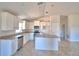 Open-concept kitchen with white cabinetry, stainless steel appliances, and an island at 136 Krenson Bay Loop, Winter Haven, FL 33881
