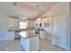 Modern kitchen with white cabinets, island, stainless steel appliances, and tile flooring at 136 Krenson Bay Loop, Winter Haven, FL 33881