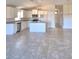 Spacious open-concept kitchen featuring an island, white cabinets and tile flooring at 136 Krenson Bay Loop, Winter Haven, FL 33881