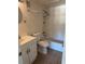 Bathroom with white tiled walls, a shower-tub combo, toilet, and a white vanity at 141 Fernery Rd # B5, Lakeland, FL 33809