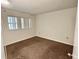 Cozy bedroom with neutral carpet and large window for natural light at 141 Fernery Rd # B5, Lakeland, FL 33809