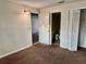Bedroom with carpet, doorways to a bathroom and living room at 141 Fernery Rd # B5, Lakeland, FL 33809