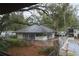 Community building with ample windows, a fenced-in patio, and lush landscaping at 141 Fernery Rd # B5, Lakeland, FL 33809