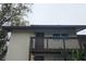 Two-story condo featuring a private balcony with wood railing and neutral exterior paint at 141 Fernery Rd # B5, Lakeland, FL 33809