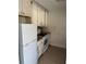 View of a kitchen featuring white cabinets and appliances at 141 Fernery Rd # B5, Lakeland, FL 33809
