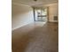 Bright living room featuring tile floors and sliding glass doors that lead to a balcony at 141 Fernery Rd # B5, Lakeland, FL 33809