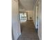 Open living room with tile flooring and sliding glass doors to the balcony provides natural light at 141 Fernery Rd # B5, Lakeland, FL 33809