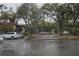 Exterior shot of the apartment complex parking lot with mature shade trees at 141 Fernery Rd # B5, Lakeland, FL 33809