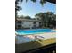 A refreshing community pool surrounded by lush greenery and seating areas, perfect for relaxation at 141 Fernery Rd # B5, Lakeland, FL 33809