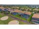 Aerial view of the community with screened pools overlooking the golf course and lake at 1420 Mickelson Ct, Davenport, FL 33896