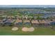 Aerial view of property near lush greenery, lakes and a scenic golf course at 1420 Mickelson Ct, Davenport, FL 33896