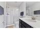 Bright bathroom with a walk-in shower, modern fixtures, and vanity with a white countertop at 1420 Mickelson Ct, Davenport, FL 33896